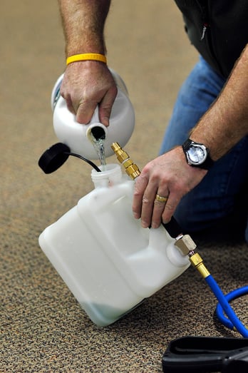 Pouring chemical into a sprayer